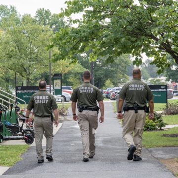 3 campus officers walking across campus